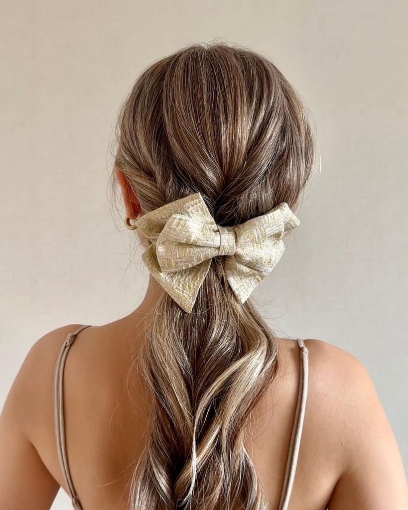 Low Twisted Ponytail with Metallic Bow